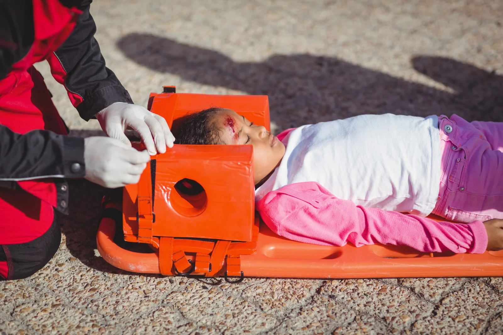 Injured girl treated by paramedic at accident spot